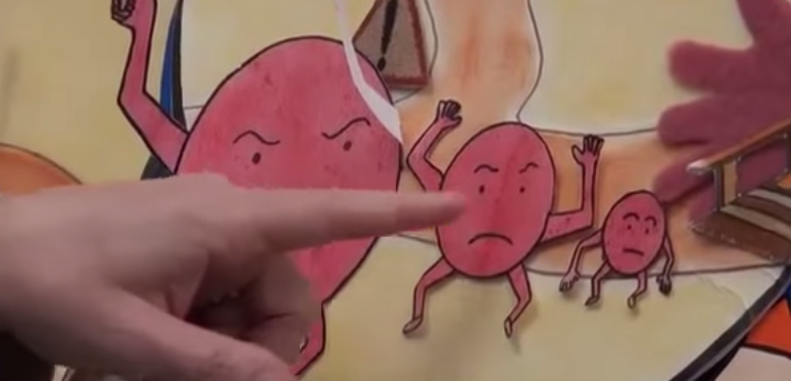 Child touching a rough card next to a tight heart drawing at the crossroads